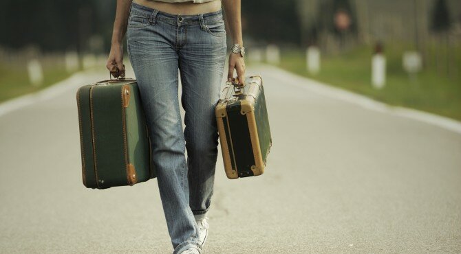 Young woman runaway walks away road. Copy space